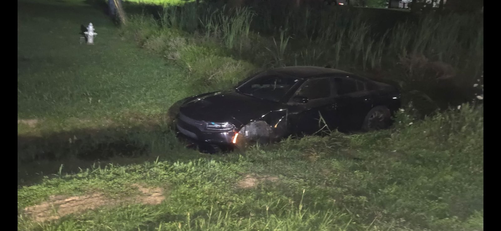 Professional changing a flat tire for a stranded driver